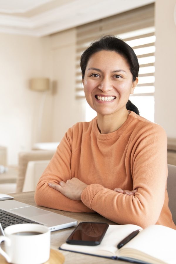 Hispanic woman is using, laptop and working from home during Covid-19